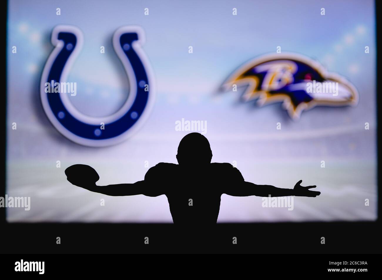 Indianapolis Colts vs. Baltimore Ravens. NFL Game. American Football League match. Silhouette of professional player celebrate touch down. Screen in b Stock Photo