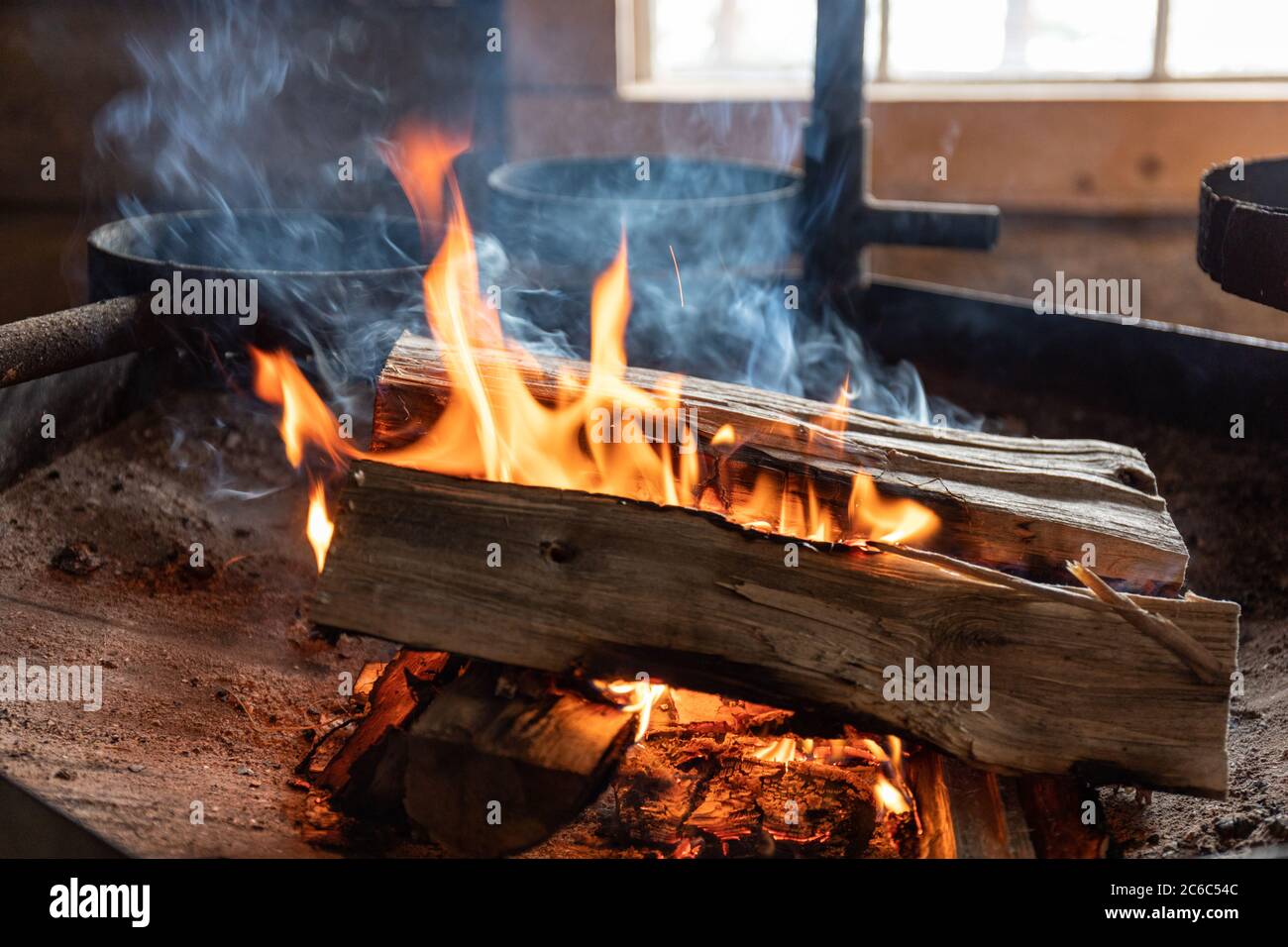 Firewood burning at open fire grilling place Stock Photo