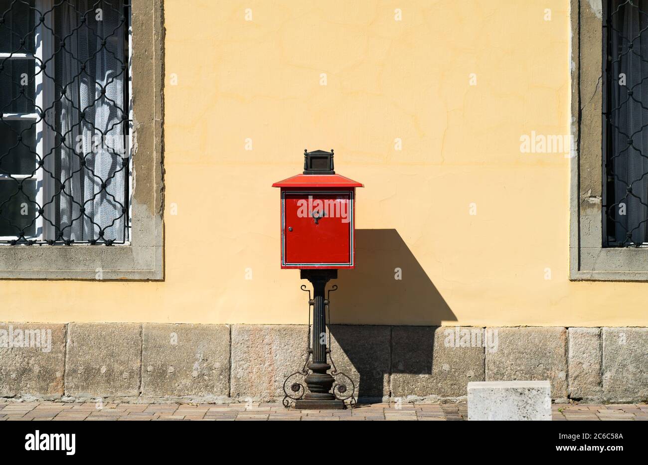 Old vintage red mailbox on the street. Stock Photo
