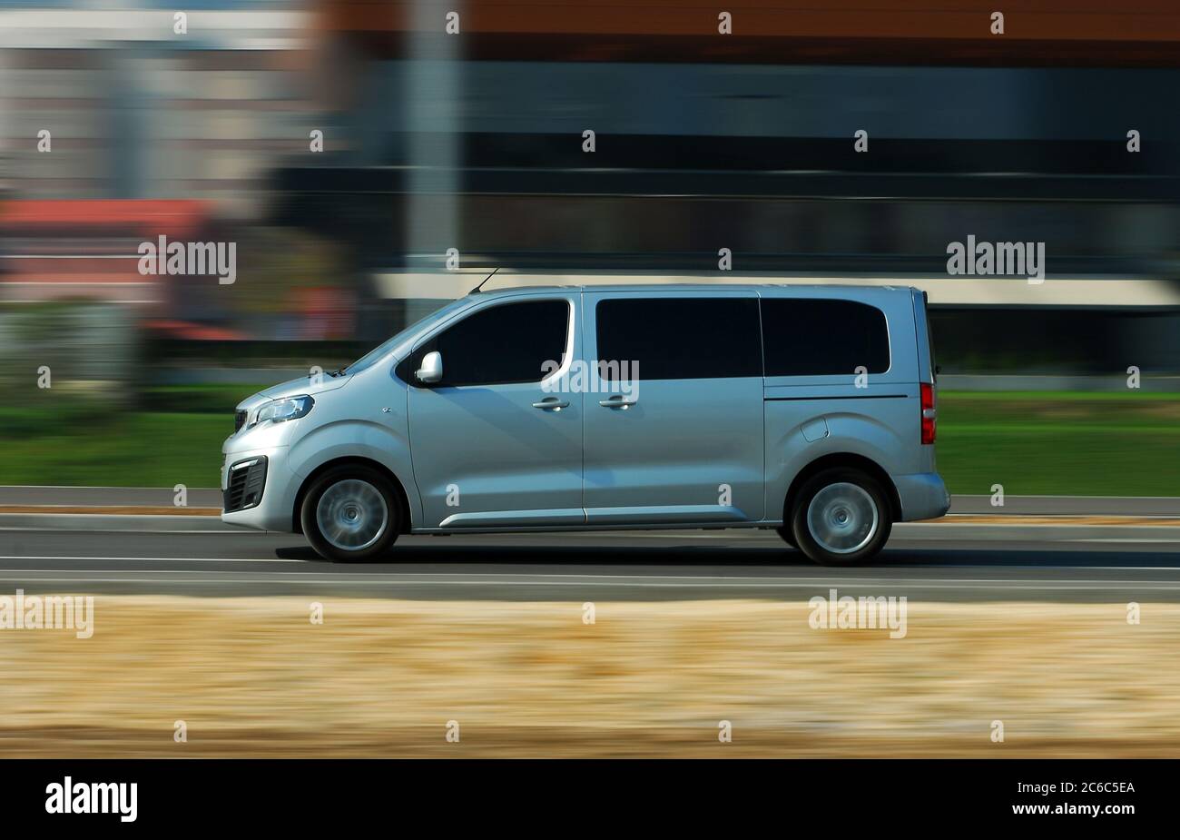 Minibus in motion. Fast moving gray minibus on the road Stock Photo - Alamy