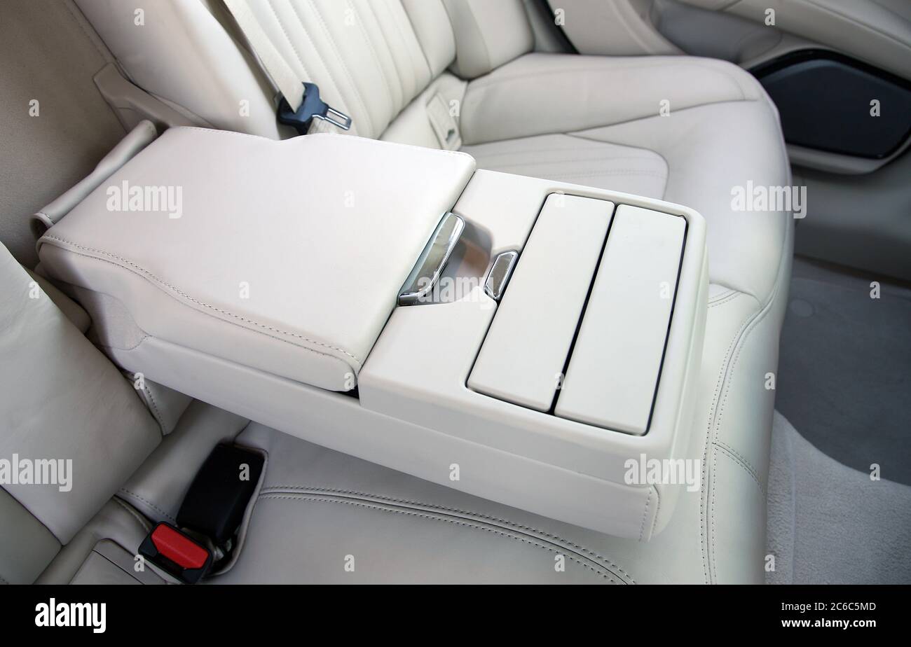 Armrest in the luxury passenger car between rear seats Stock Photo