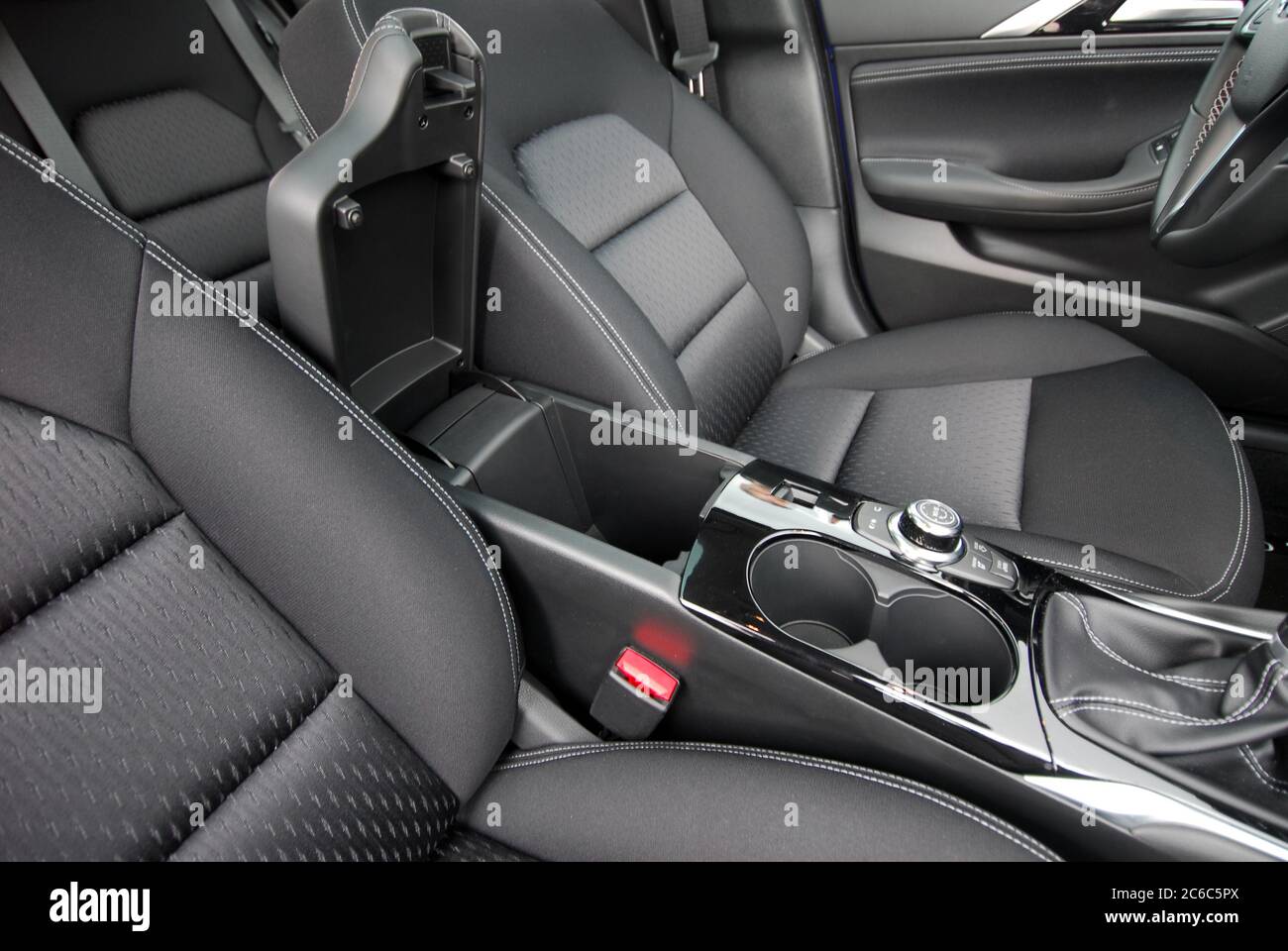 Open glove compartment box inside modern car. Open storage box between