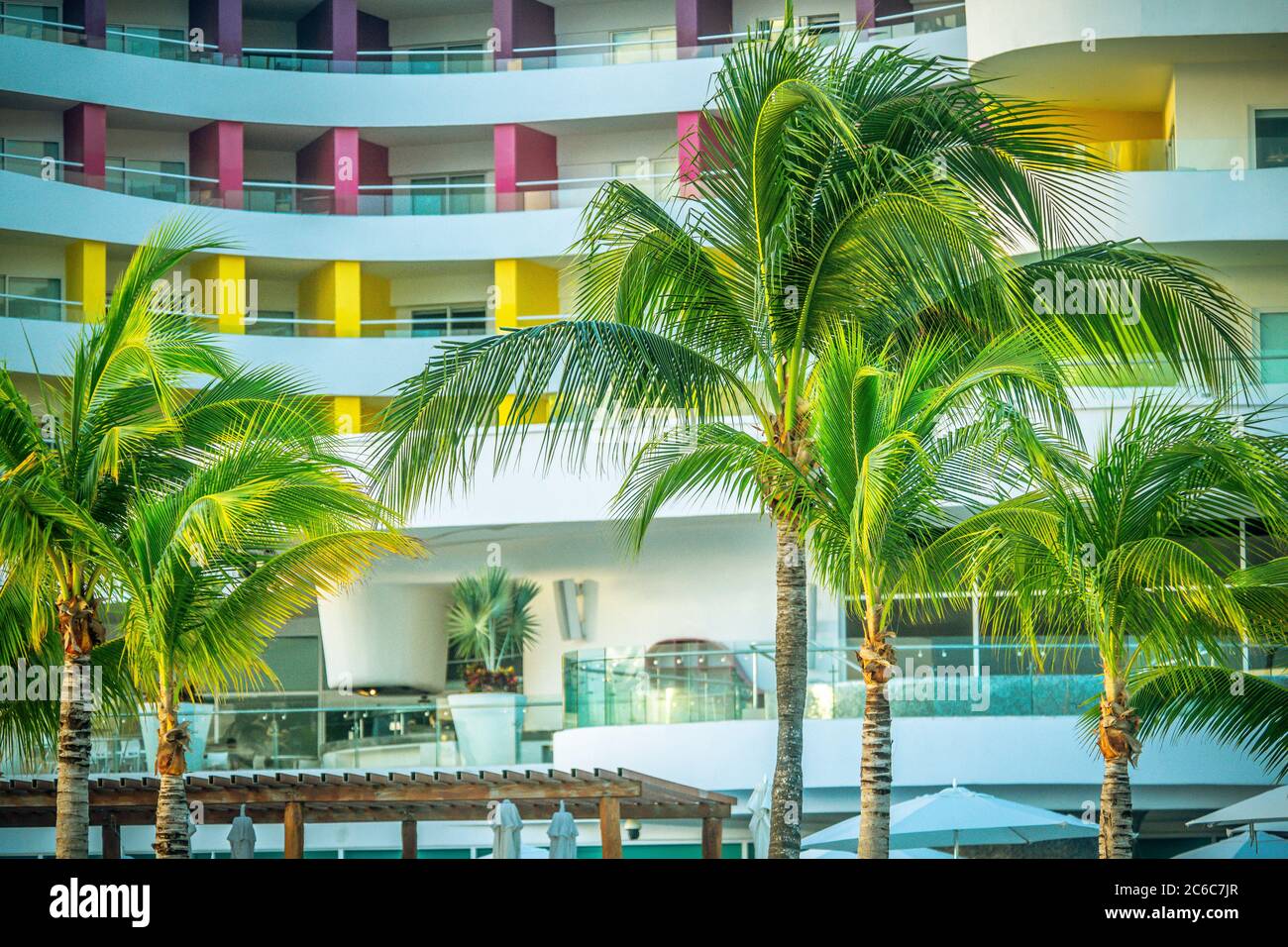 Palm trees in front of a tropical resort Stock Photo
