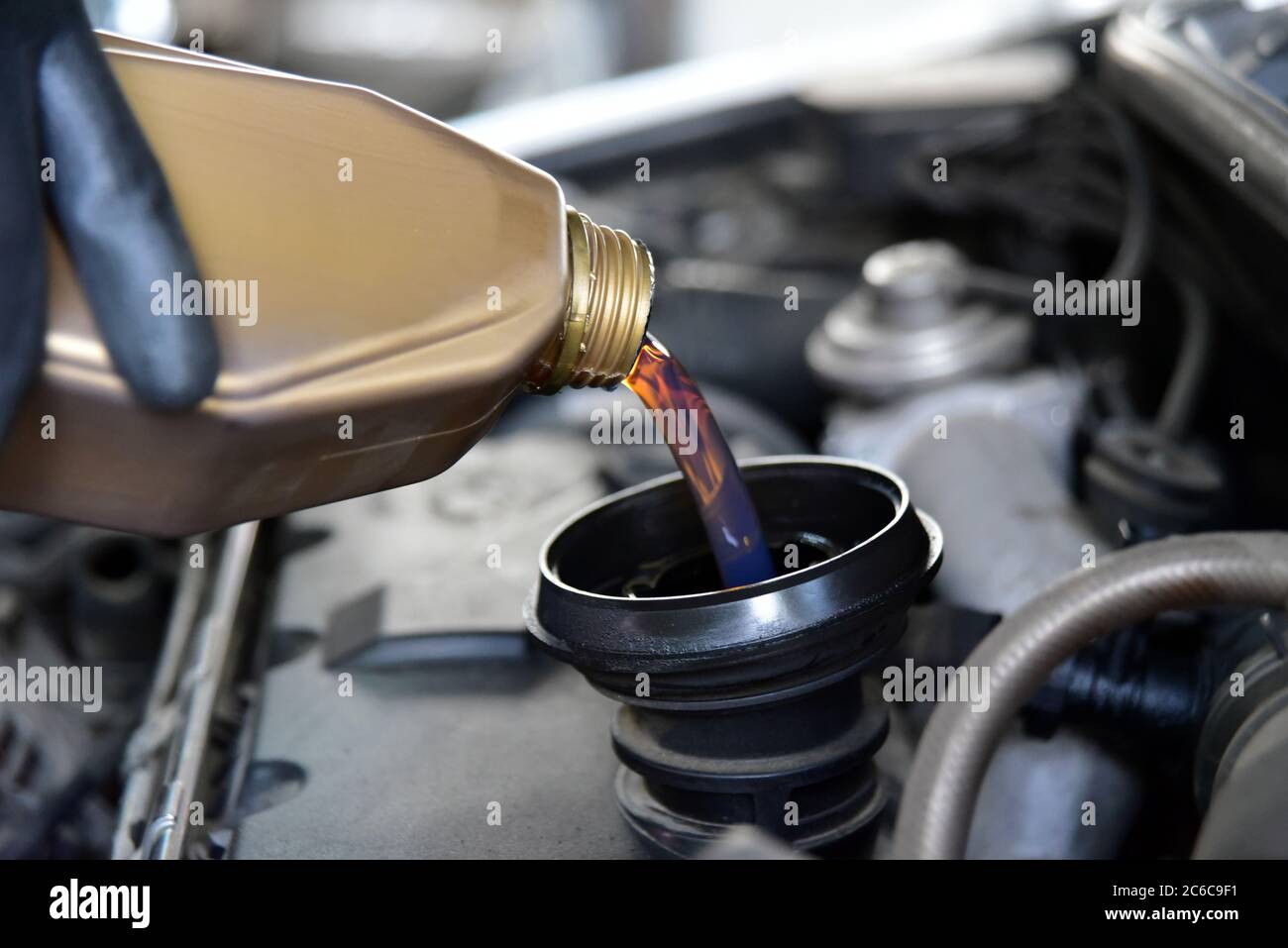 Adding oil to the car engine Stock Photo Alamy