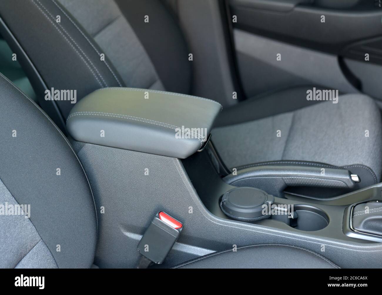 Armrest in the luxury passenger car between the front seats. Stock Photo
