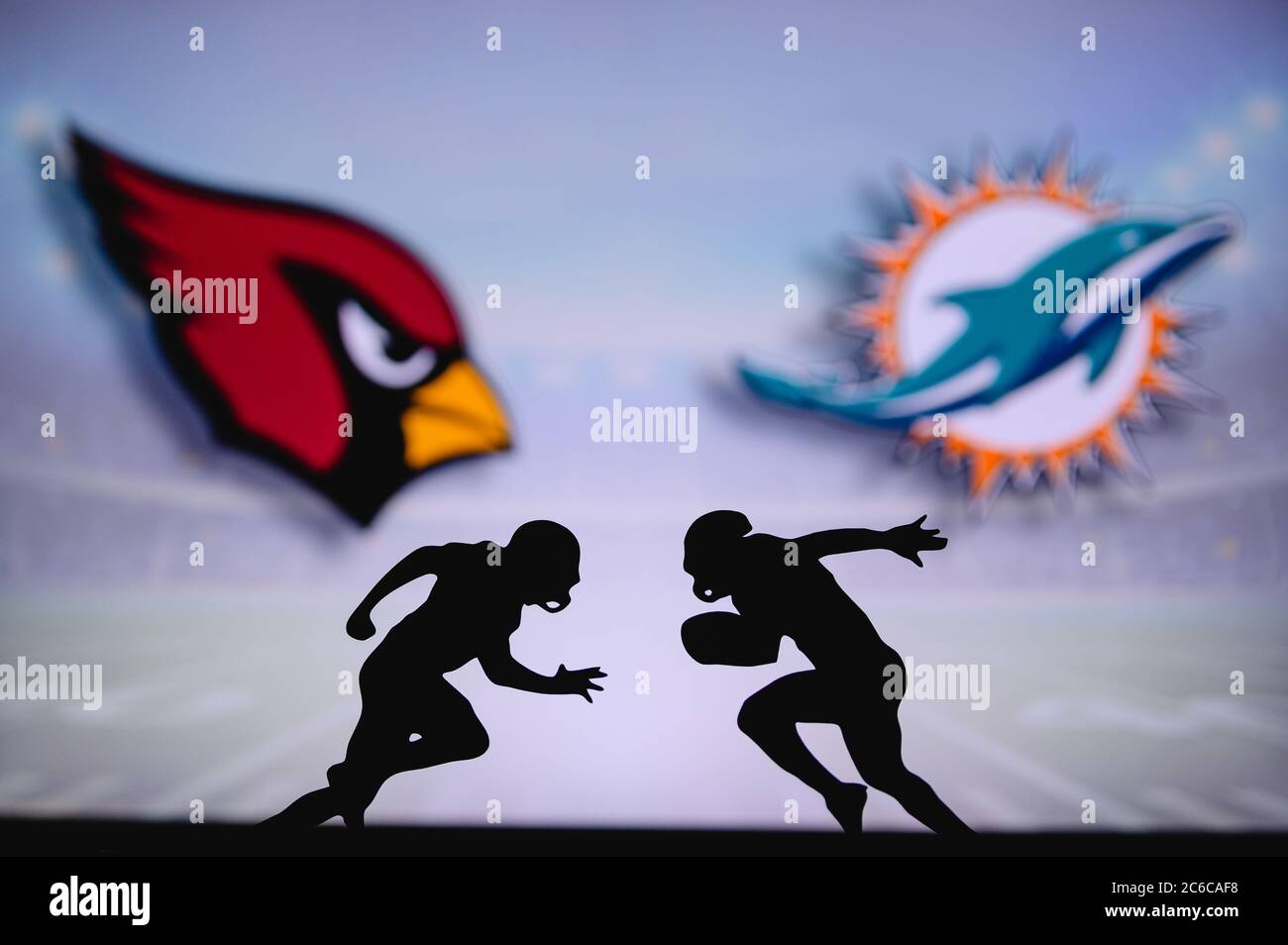 Arizona Cardinals vs. Miami Dolphins. NFL match poster. Two american football players silhouette facing each other on the field. Clubs logo in backgro Stock Photo