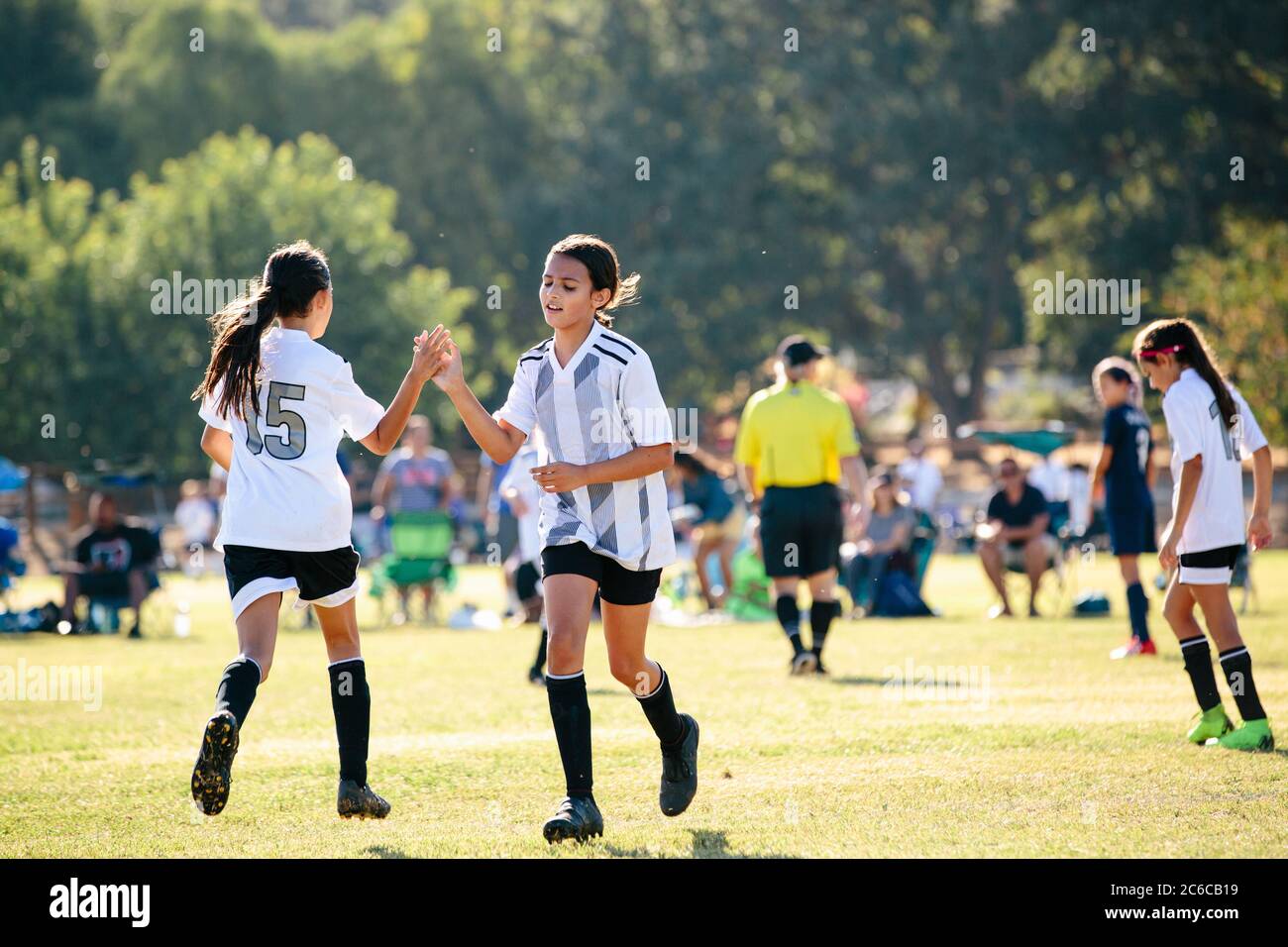 Soccer player girl gives her teammate a high five Stock Photo