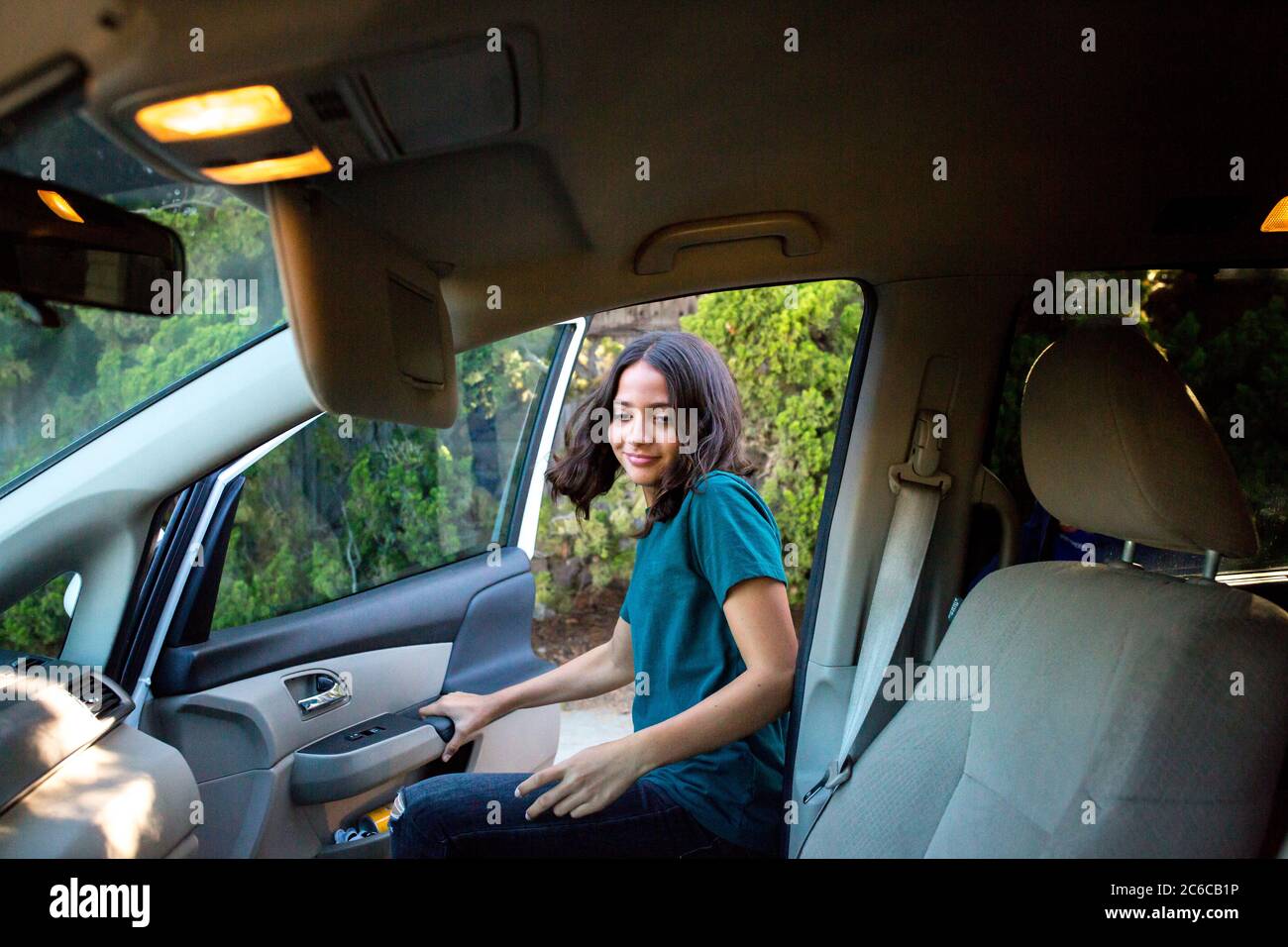 https://c8.alamy.com/comp/2C6CB1P/tween-girl-enters-the-car-to-sit-in-the-front-seat-2C6CB1P.jpg