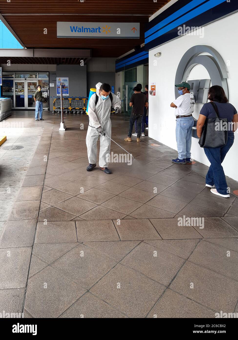 Man in protective suit disinfecting a mall in guatemala city Stock Photo
