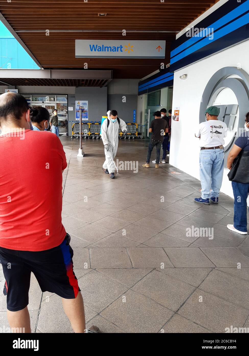 Man in protective suit disinfecting a mall in guatemala city Stock Photo