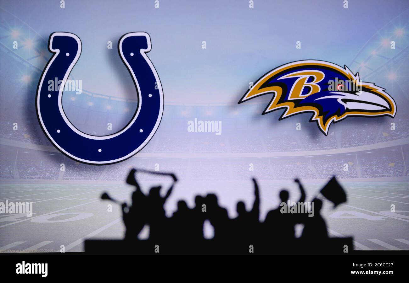 Indianapolis Colts vs. Baltimore Ravens. Fans support on NFL Game. Silhouette of supporters, big screen with two rivals in background. Stock Photo