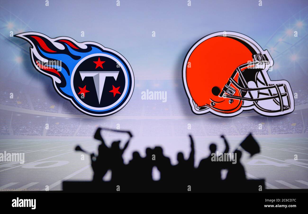 Tennessee Titans vs. Cleveland Browns. Fans support on NFL Game. Silhouette of supporters, big screen with two rivals in background. Stock Photo