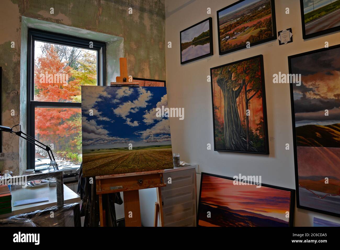 Alton, Ontario / Canada - 10/09/2015: View of an art studio with paintings on the wall and easel. Stock Photo