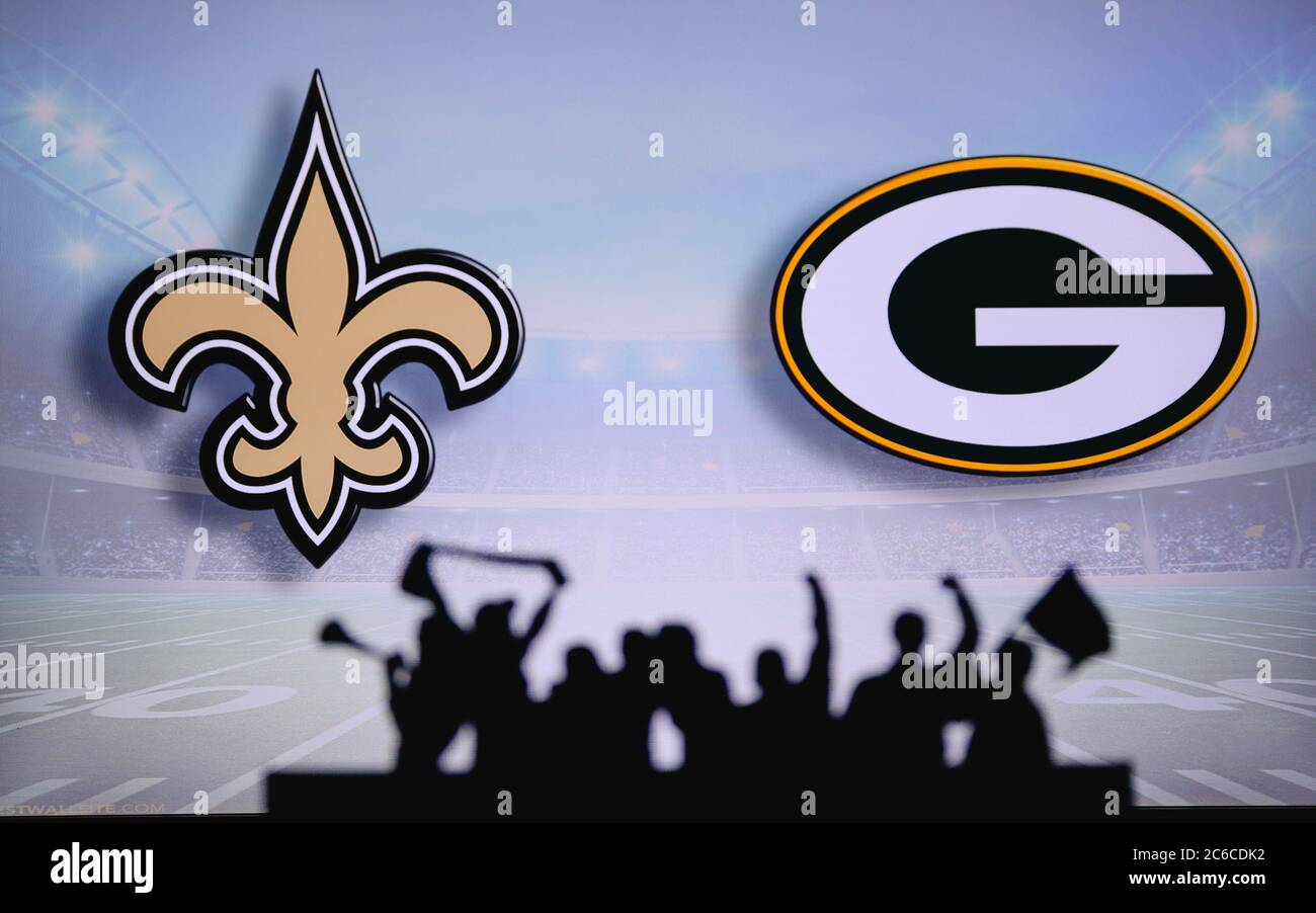 New Orleans Saints vs. Green Bay Packers. Fans support on NFL Game. Silhouette of supporters, big screen with two rivals in background. Stock Photo