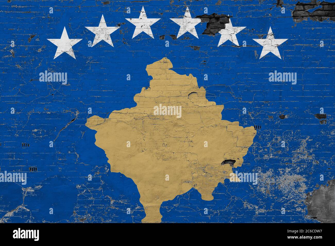 Kosovo flag on grunge scratched concrete surface. National vintage background. Retro wall concept. Stock Photo