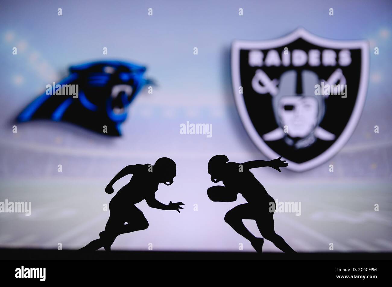Carolina Panthers vs. Las Vegas Raiders. NFL match poster. Two american football players silhouette facing each other on the field. Clubs logo in back Stock Photo