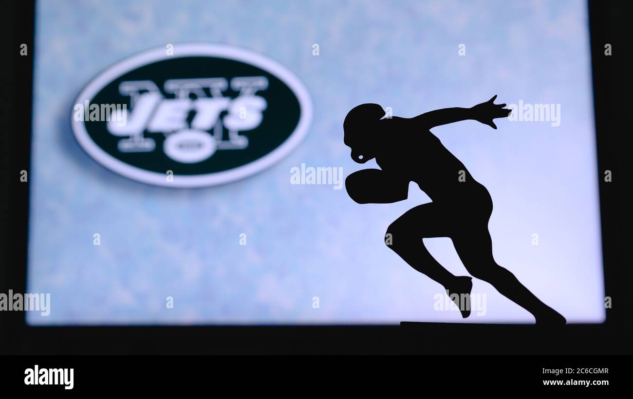 New York Jets. Silhouette of professional american football player. Logo of NFL club in background, edit space. Stock Photo