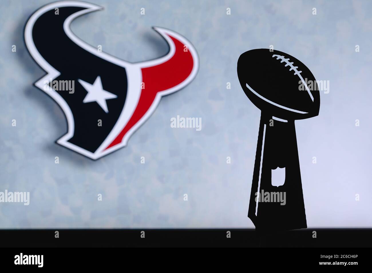 Houston Texans professional american football club, silhouette of NFL trophy, logo of the club in background. Stock Photo