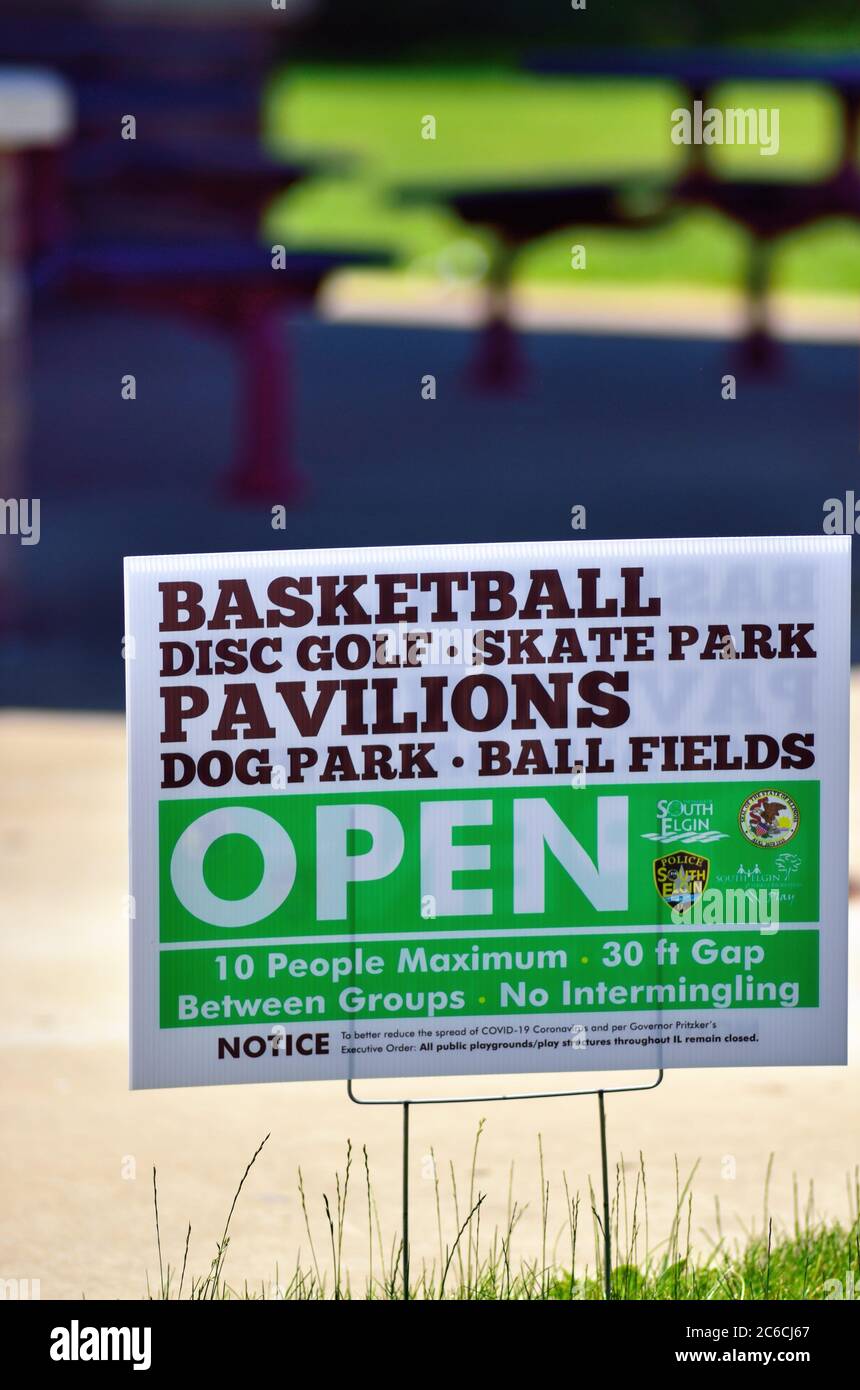 South Elgin, Illinois, USA. A sign announcing the reopening of select park facilities as restrictions were being eased during the COVID-19 pandemic. Stock Photo