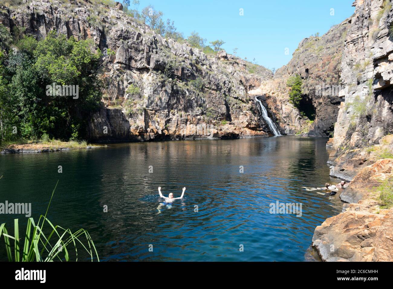 Tourists swimming at popular Maguk (Barramundi Gorge) waterfalls and plunge pool, Kakadu National Park, Northern Territory, NT, Australia Stock Photo