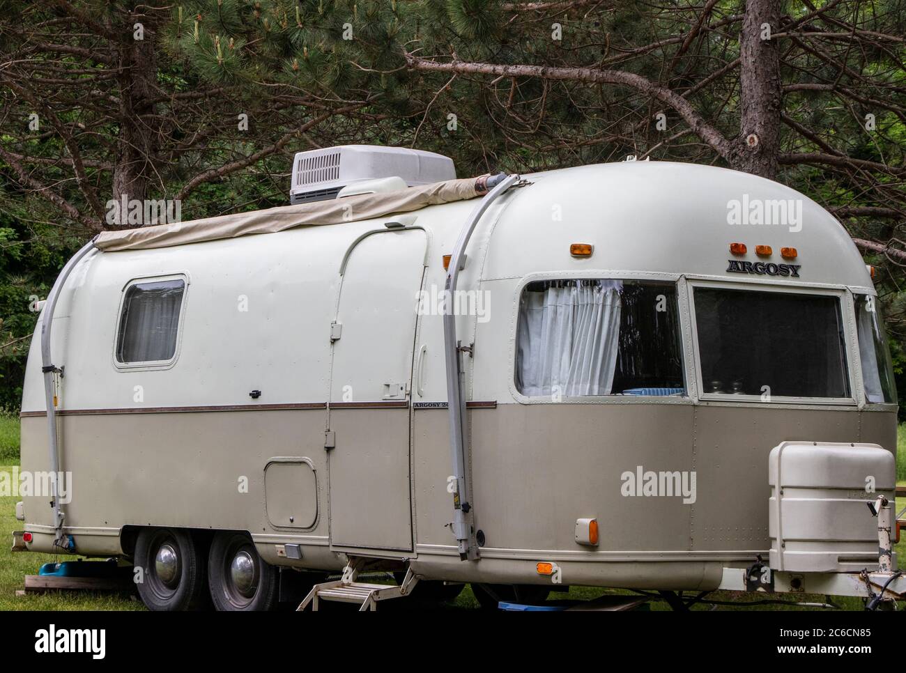 June 13, 2020 - Frelighsburg, Québec, Canada: Argosy Airstream Caravan Painted 1970s Line on a campground during holiday made in USA Stock Photo