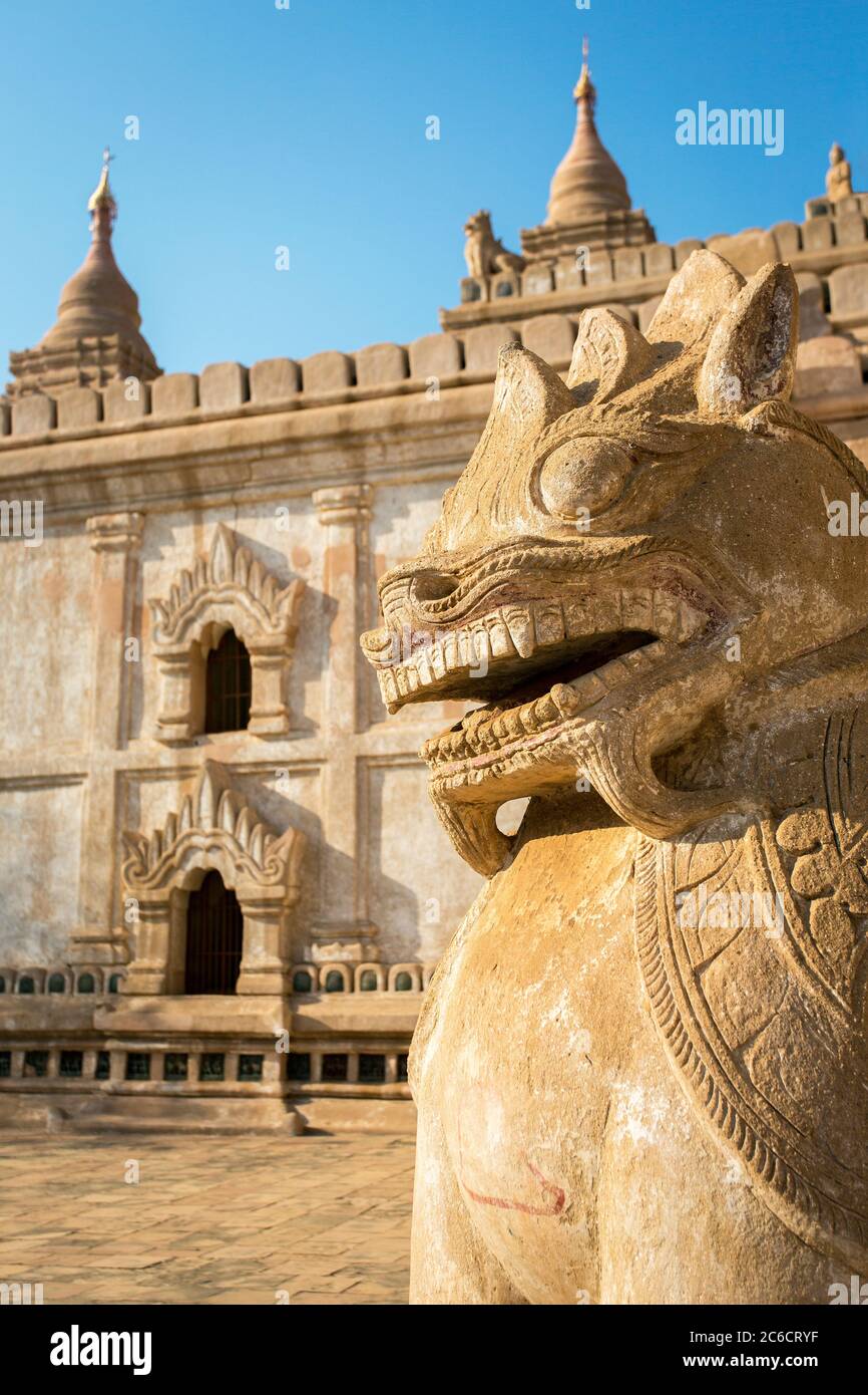 A close-up view of a carved stone statue of a chinthe (lion) at the Ananda Buddhist Temple in Yangon, Myanmar Stock Photo