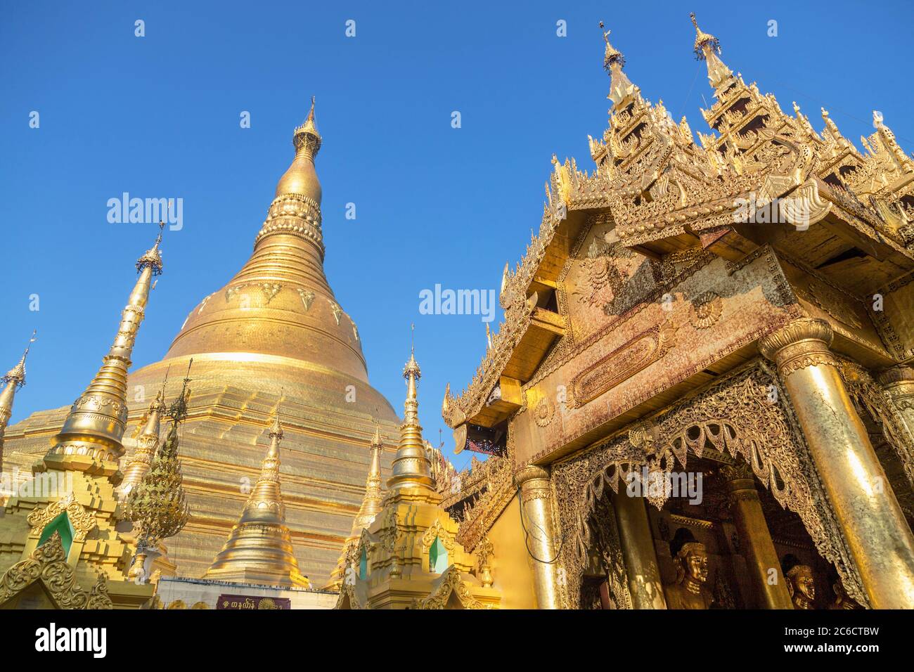 A low angle view of gilded stupas and gilded carvings at the Shwedagon Pagoda in Yangon, Myanmar Stock Photo