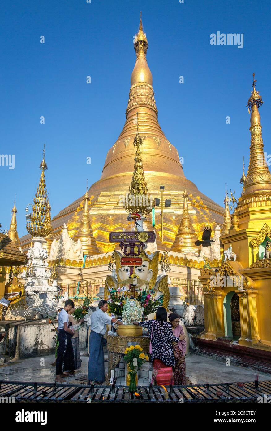 Believers participate in the ceremonial washing of the Nats at the Shwedagon Pagoda in Yangoon, Myanmar Stock Photo