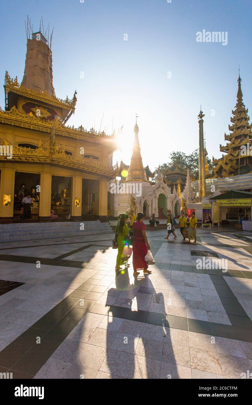 Believers walk around the interior of the Shwedagon Pagoda in Yangon, Myanmar Stock Photo