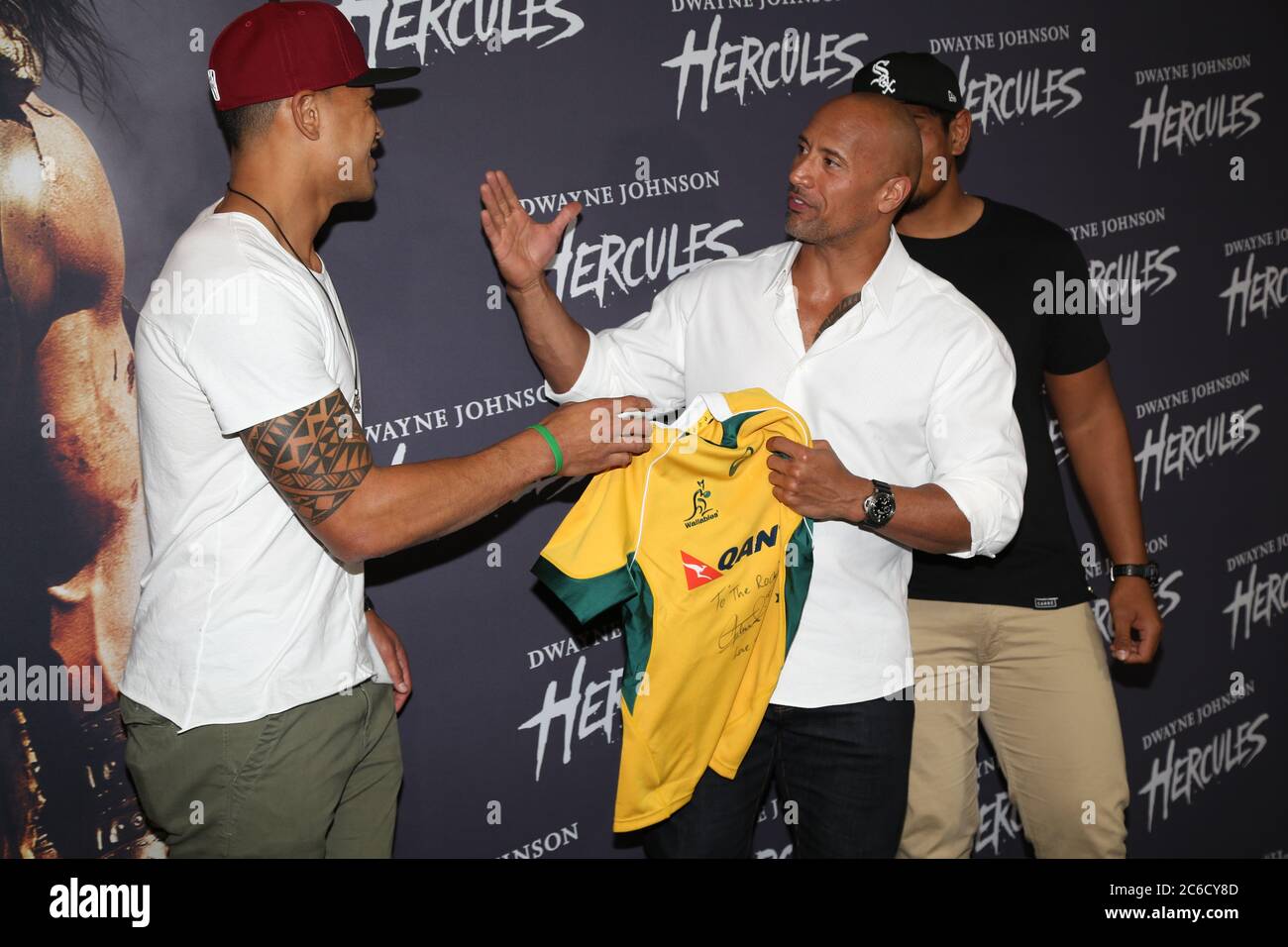 Australian Rugby Union Nsw Waratahs Players Israel Folau Left And Will Skelton Right Present Dwyane Johnson With A Signed Qantas Wallabies Jersey Stock Photo Alamy