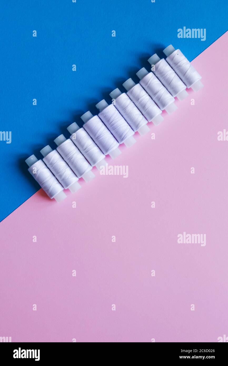 Row Of WhiteThread Spools On Table flatlay Stock Photo