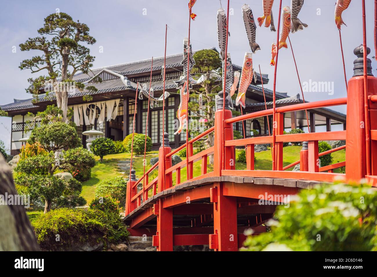 A red bridge over water in a Japanese garden Stock Photo - Alamy