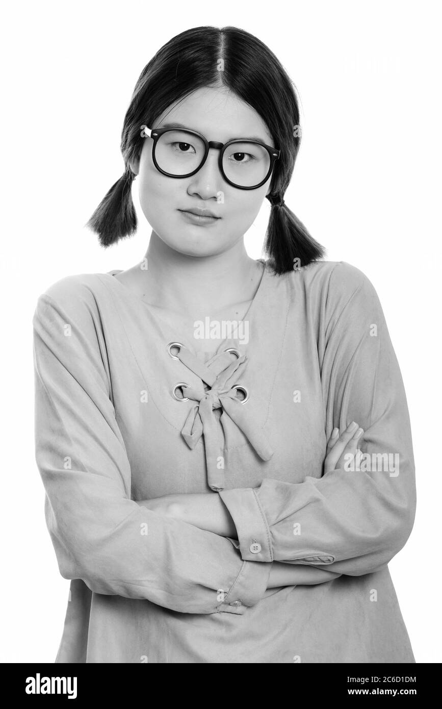 Studio shot of young angry Asian woman with arms crossed Stock Photo