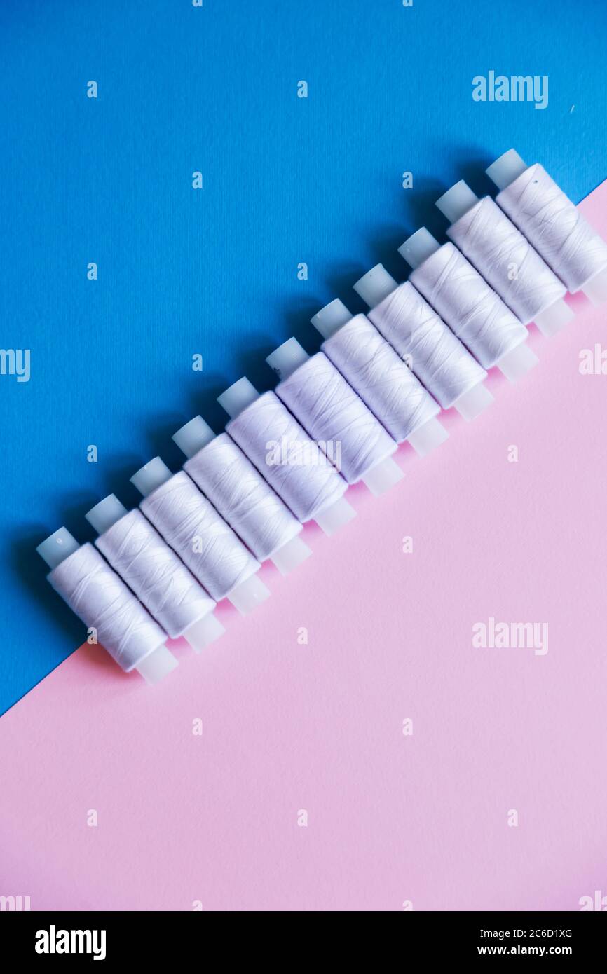 Row Of WhiteThread Spools On Table flatlay Stock Photo