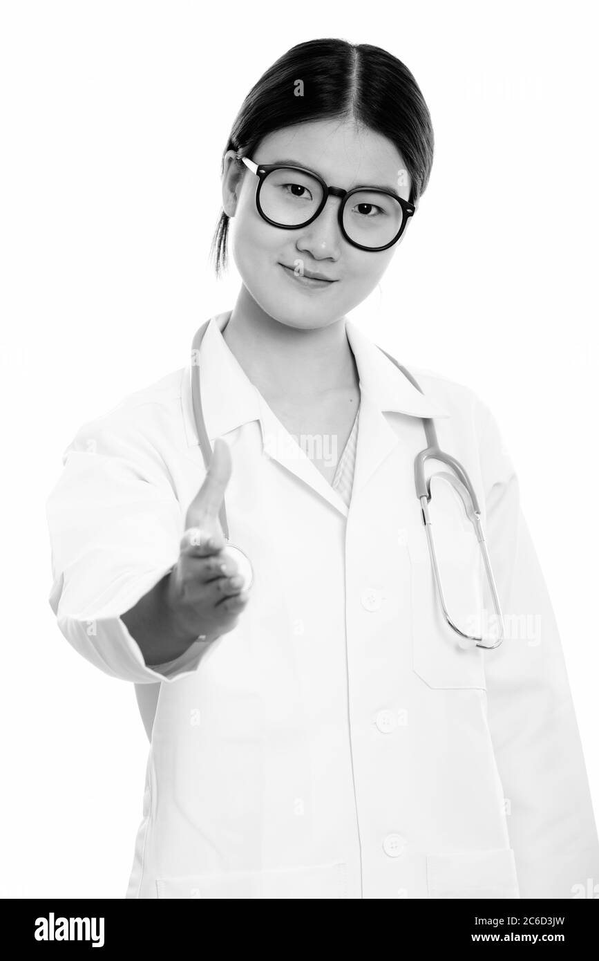 Studio shot of young beautiful Asian woman doctor giving handshake ...