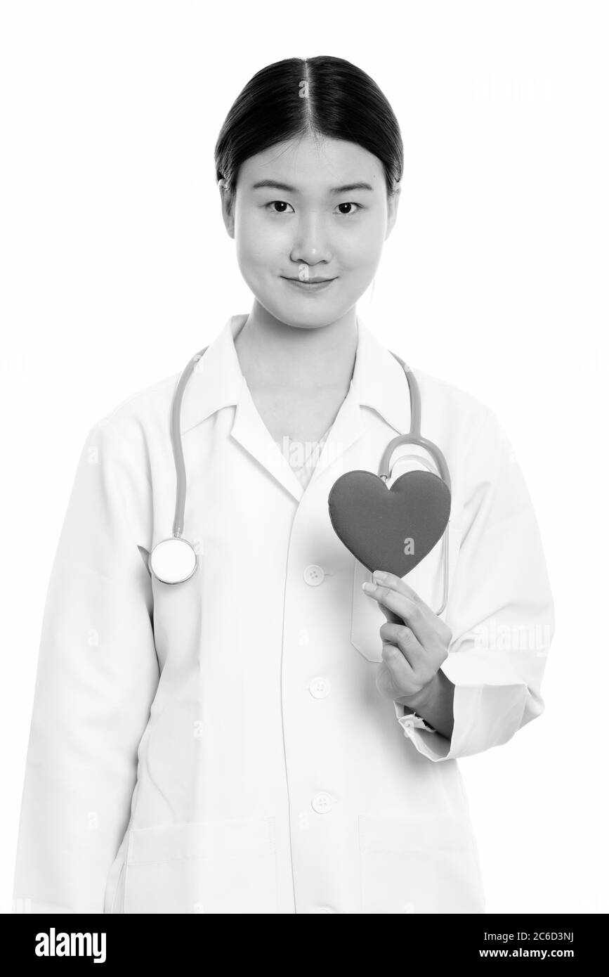 Young beautiful Asian woman doctor holding red heart Stock Photo - Alamy