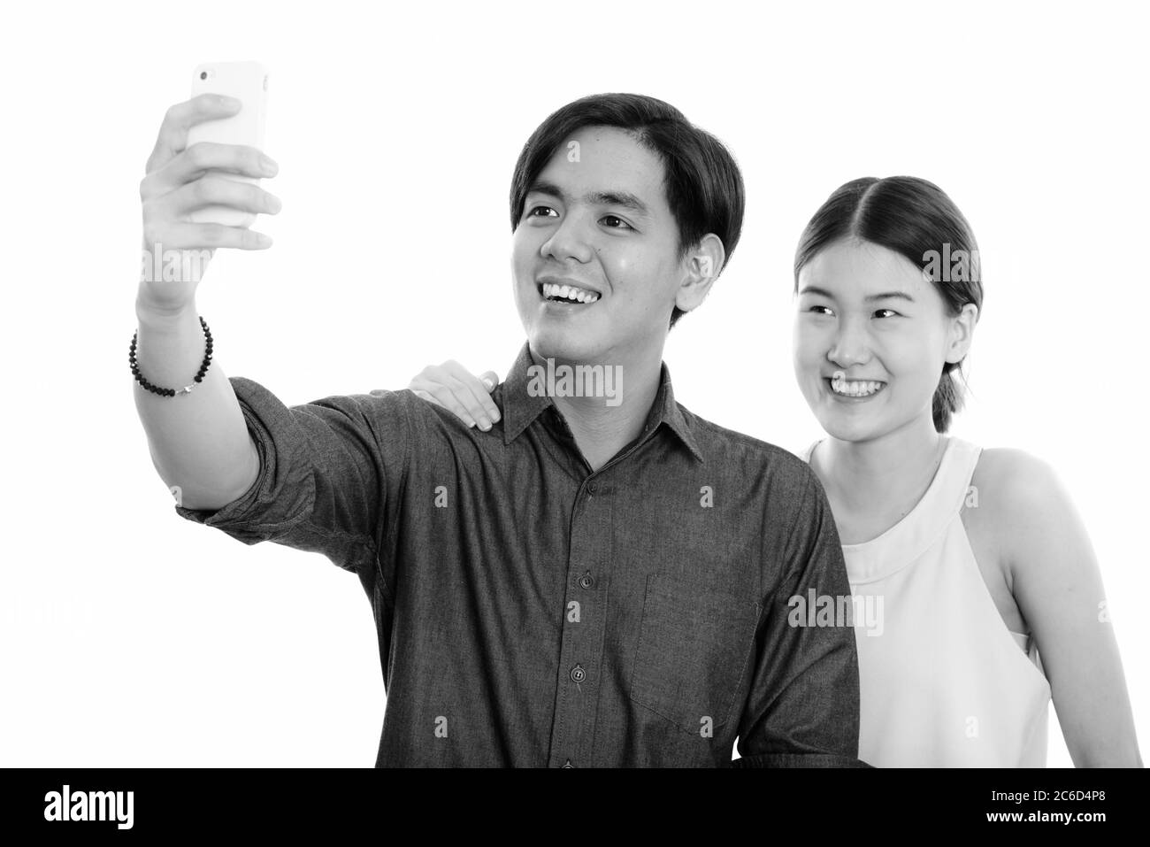Young happy Asian couple smiling while taking selfie picture with ...