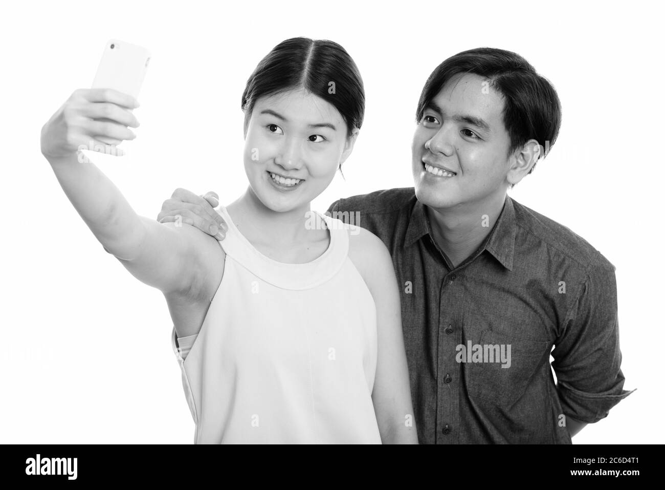 Young happy Asian couple smiling while taking selfie picture with ...