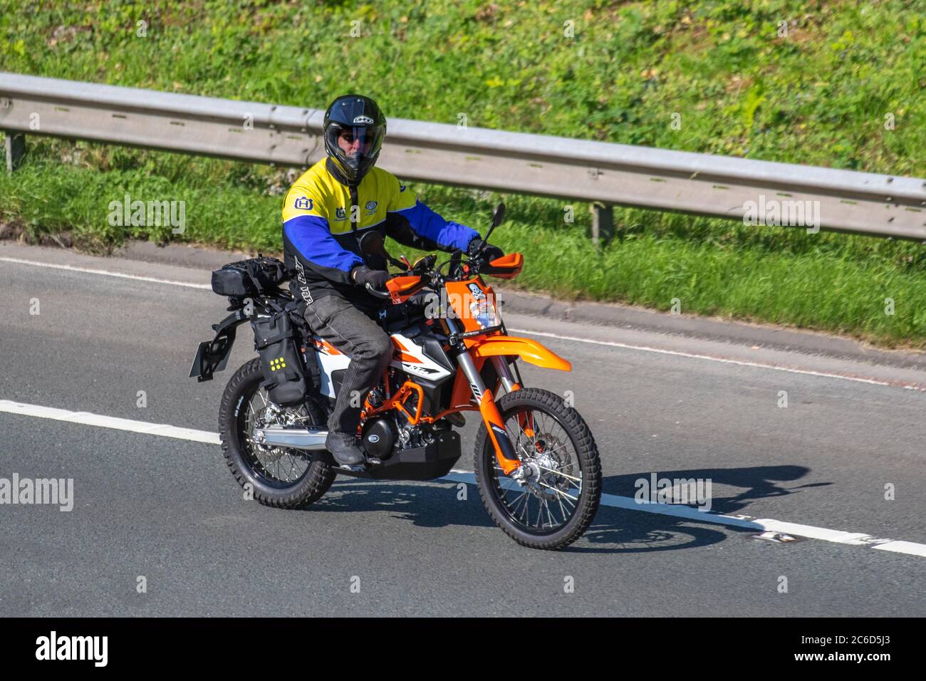 Orange KTM Motorbike rider; two wheeled transport, motorcycles, vehicle, roads, motorbikes, bike riders motoring in Chorley, UK Stock Photo