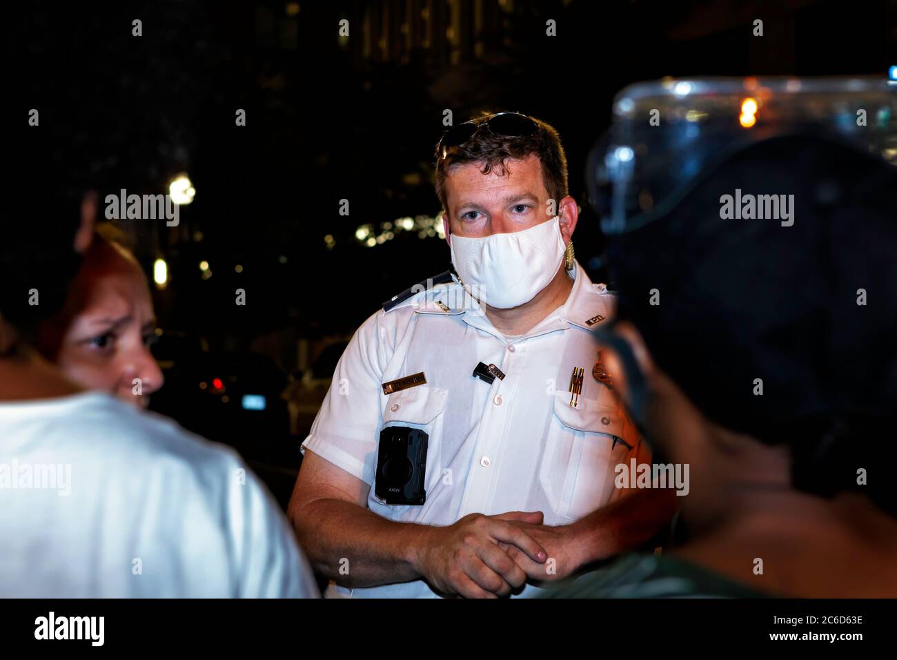 DC police Lt. Bagshaw talks with protesters at BLM Plaza about their demands for input on changes in policing, Washington, DC, United States Stock Photo