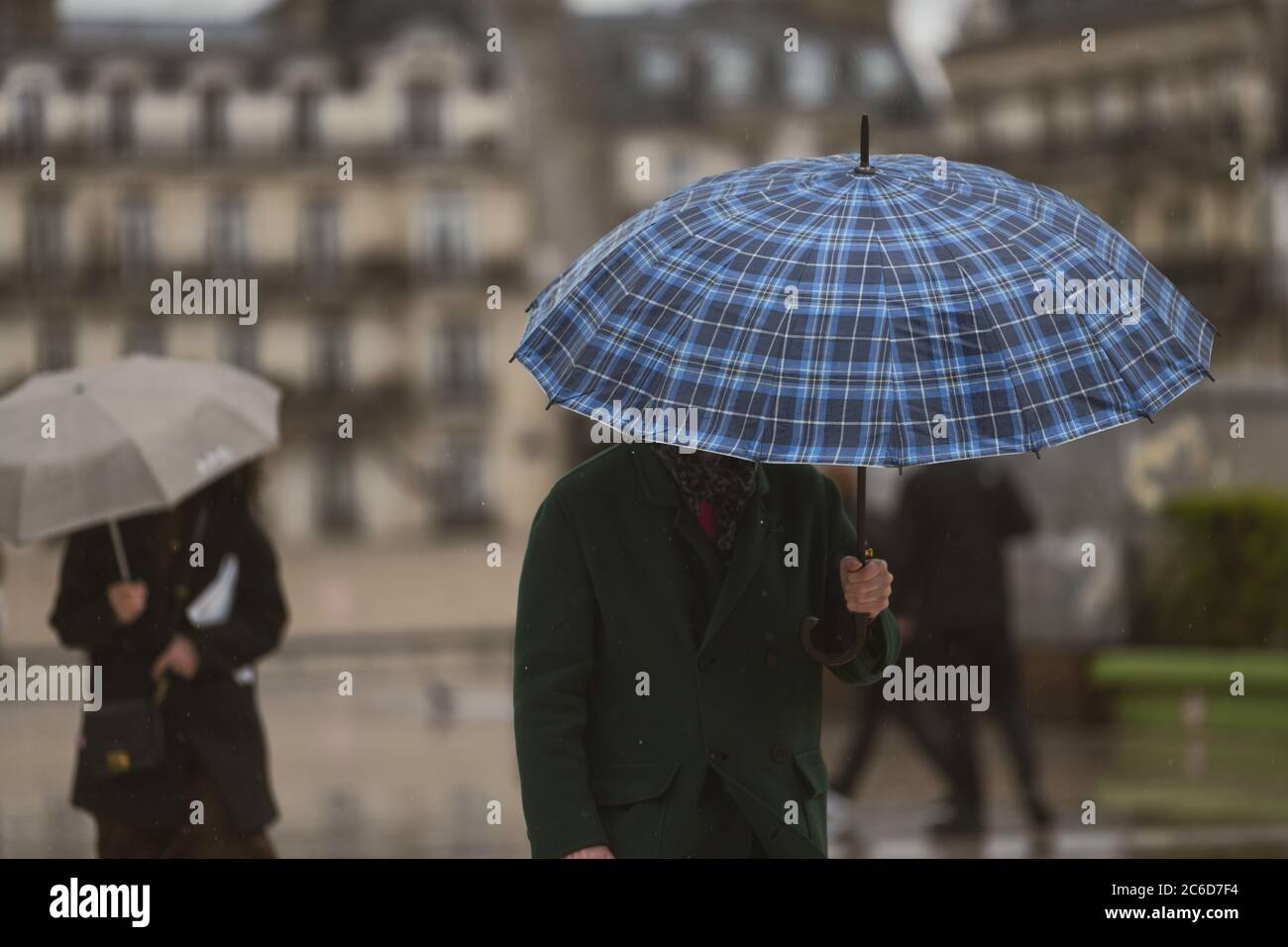 People with an umbrella in a rainy day in Paris Stock Photo - Alamy