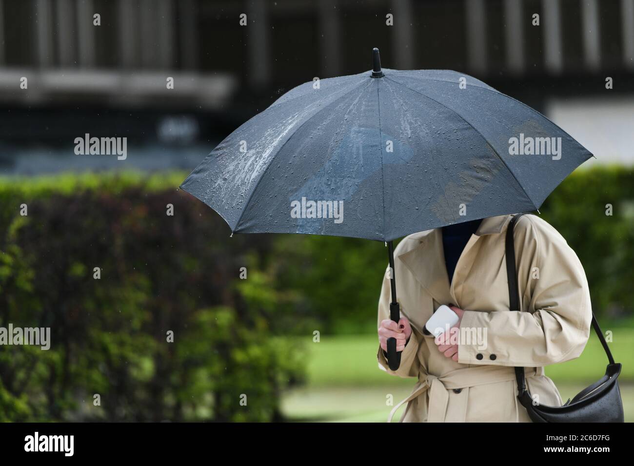 People with an umbrella in a rainy day in Paris Stock Photo - Alamy
