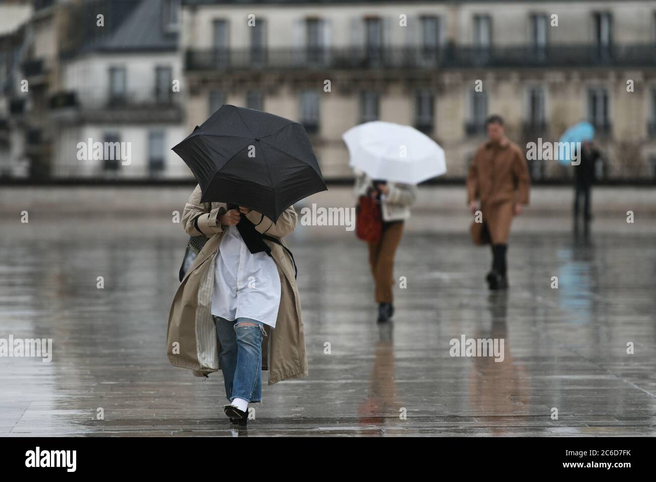 People with an umbrella in a rainy day in Paris Stock Photo - Alamy