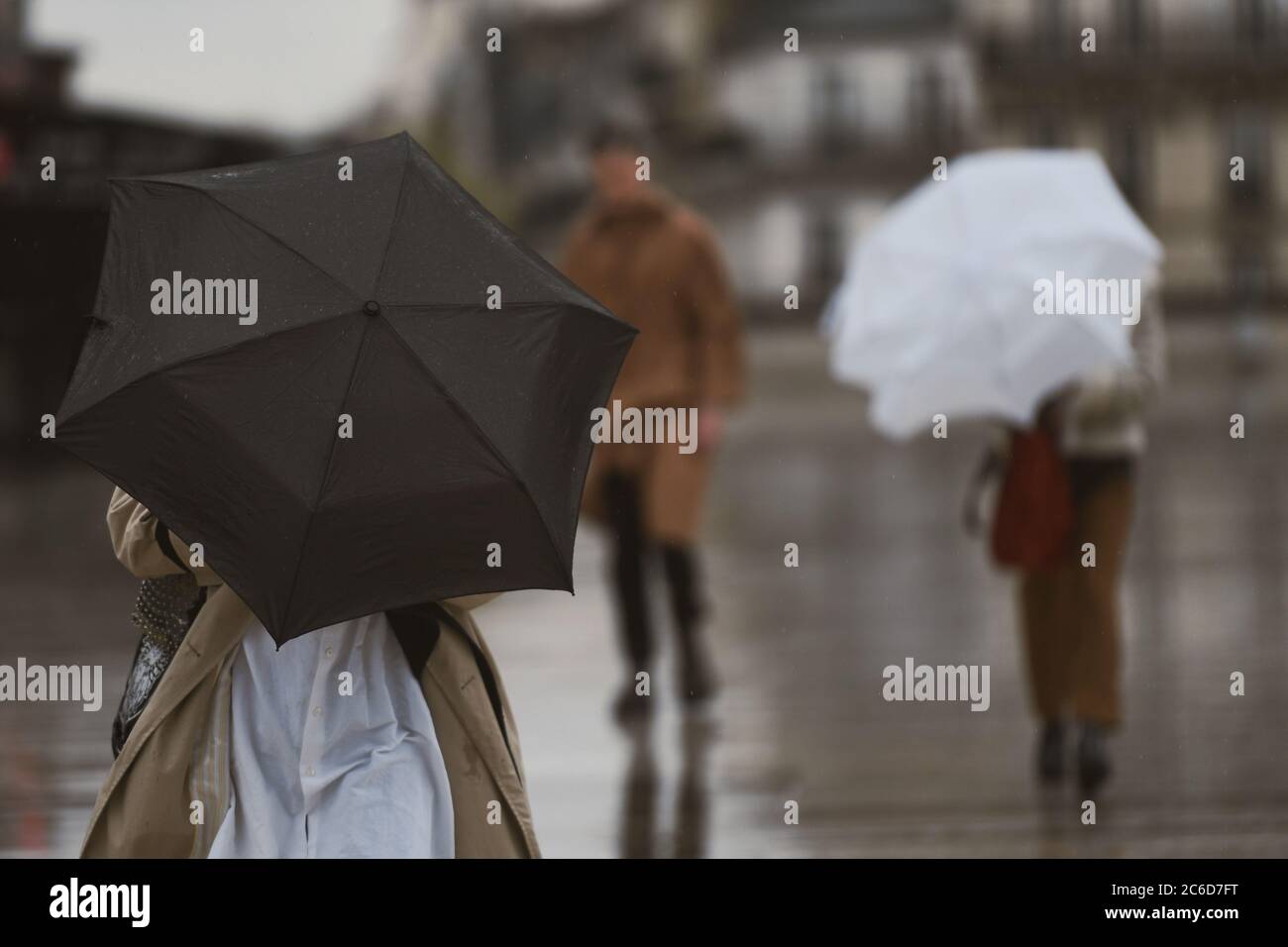 People with an umbrella in a rainy day in Paris Stock Photo - Alamy