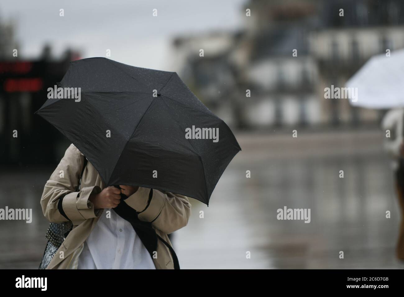 People with an umbrella in a rainy day in Paris Stock Photo - Alamy