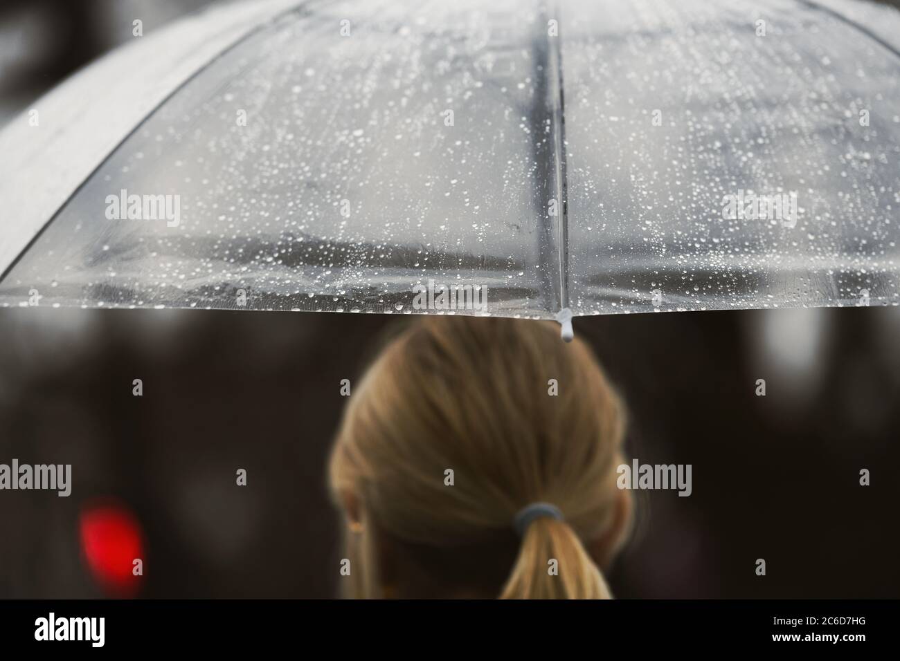 Paris, France - February 27, 2020: Girl with an umbrella in a rainy day ...