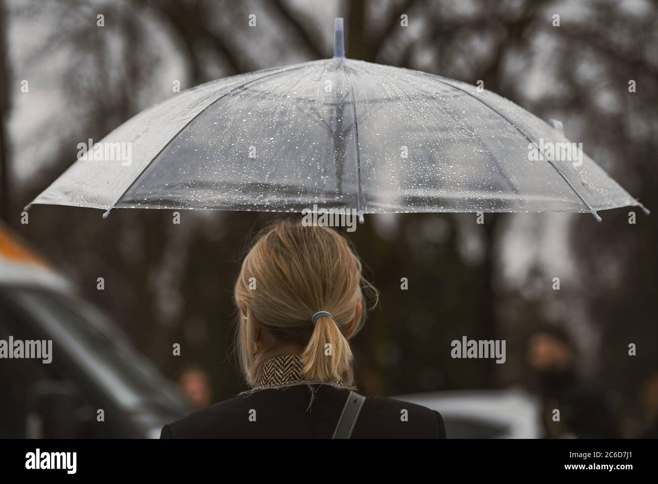 Paris, France - February 27, 2020: Girl with an umbrella in a rainy day ...