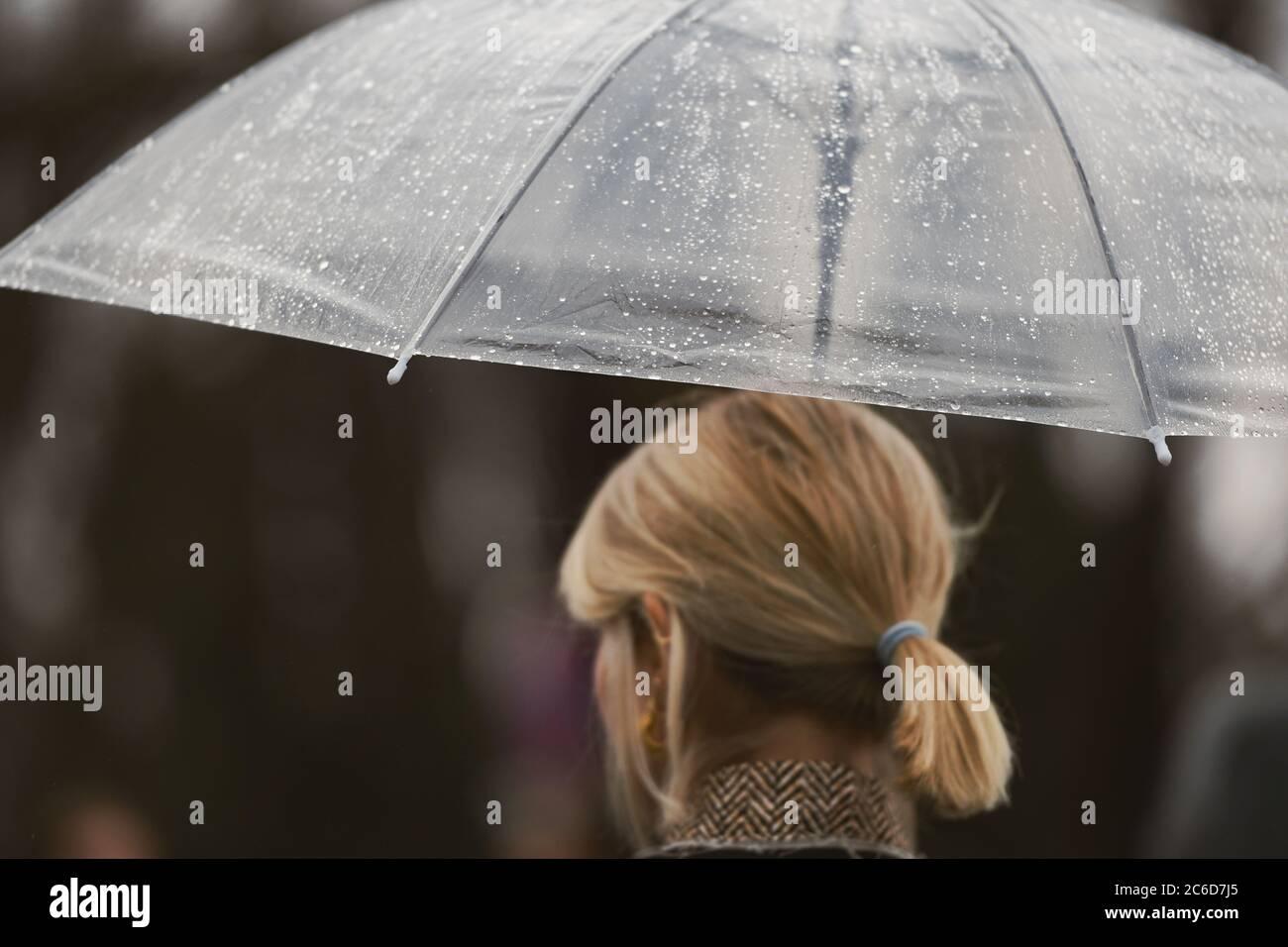 Paris, France - February 27, 2020: Girl with an umbrella in a rainy day ...