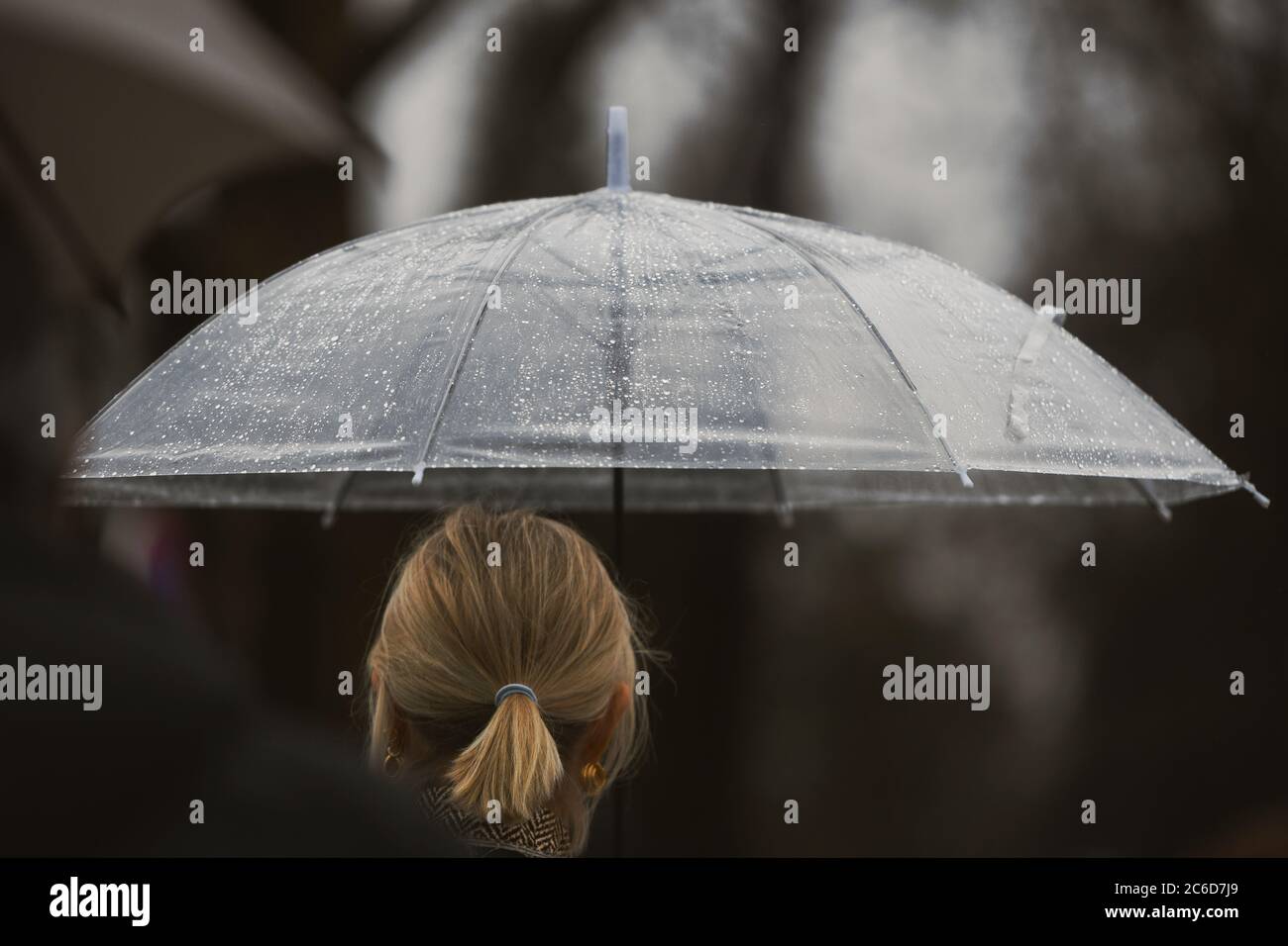 Paris, France - February 27, 2020: Girl with an umbrella in a rainy day ...