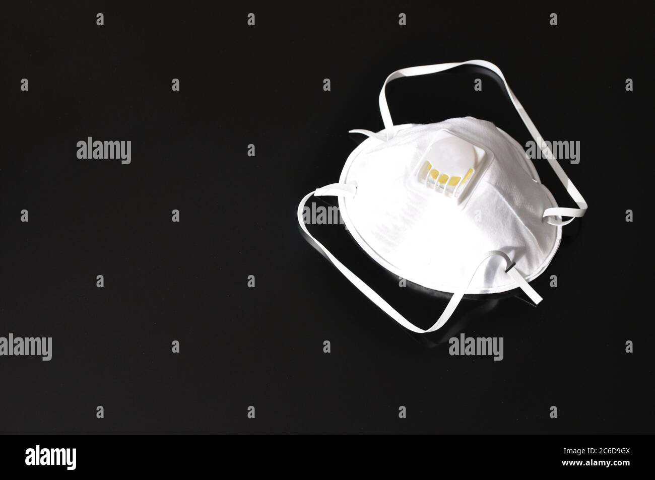 Set of white masks on a black background. Respirator with ventilation ...